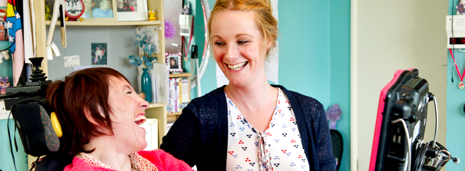 Carer and lady laughing together